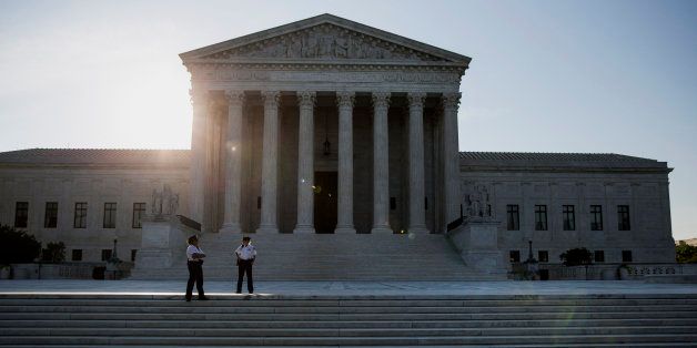 Police officers stand in front of the U.S. Supreme Court in Washington, D.C., U.S., on Monday, June 22, 2015. The high court will decide by the end of the month whether the Constitution gives gays the right to marry. The court's actions until now have suggested that a majority of the nine justices will vote to legalize same-sex weddings nationwide. Photographer: Drew Angerer/Bloomberg via Getty Images