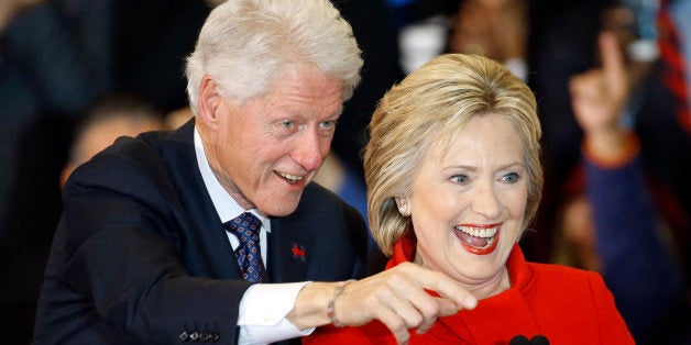 Former President Bill Clinton, left, and Democratic presidential candidate Hillary Clinton acknowledge supporters during a caucus night rally at Drake University in Des Moines, Iowa, Monday, Feb. 1, 2016. (AP Photo/Patrick Semansky)