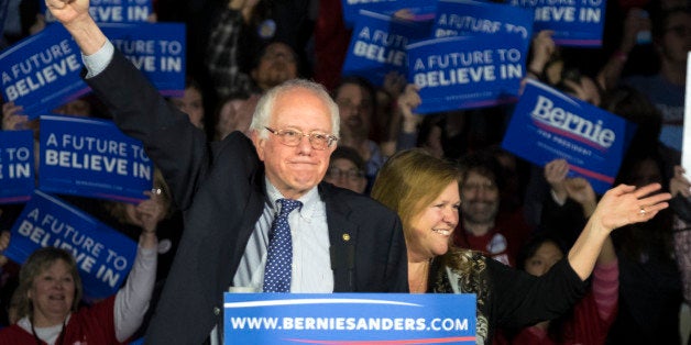 Democratic presidential candidate, Sen. Bernie Sanders, I-Vt, and his wave Jane acknowledge the crowd as he arrives for his caucus night rally in Des Moines, Iowa, Monday, Feb. 2, 2016. (AP Photo/Patrick Semansky)