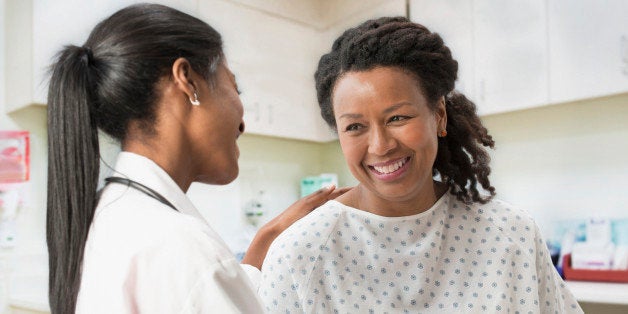 Doctor comforting patient in office