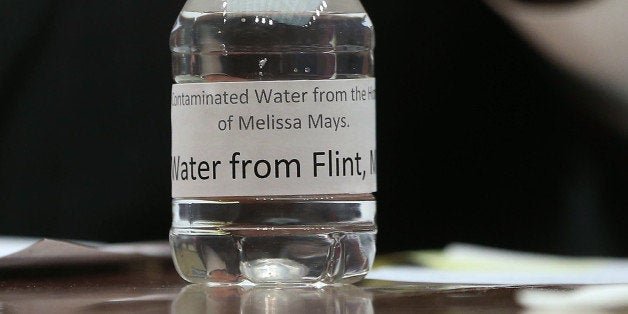 WASHINGTON, DC - FEBRUARY 03: A bottle of contaminated Flint tap water sits on the witness table while Rep. Dan Kildee (D-MI) speaks, during a House Oversight and Government Reform Committee hearing on the Flint, Michigan water crisis on Capitol Hill February 3, 2016 in Washington, DC. The committee heard testimony on the Federal Administration of the Safe Drinking Water Act in Flint, Michigan. (Photo by Mark Wilson/Getty Images)