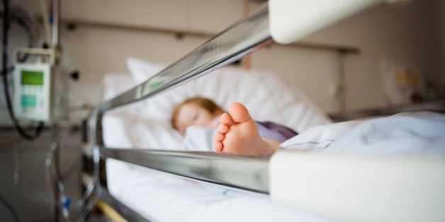 Young girl is lying in a hospital bed