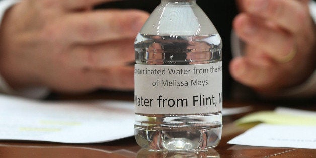 WASHINGTON, DC - FEBRUARY 03: A bottle of contaminated Flint tap water sits on the witness table while Rep. Dan Kildee (D-MI) speaks, during a House Oversight and Government Reform Committee hearing on the Flint, Michigan water crisis on Capitol Hill February 3, 2016 in Washington, DC. The committee heard testimony on the Federal Administration of the Safe Drinking Water Act in Flint, Michigan. (Photo by Mark Wilson/Getty Images)