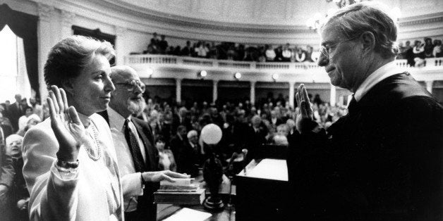 Madeleine Kunin is sworn in by Supreme Court Chief Justice Fred Allen at the Statehouse in Montpelier, Vt. on Jan 10, 1984. An overflowing crowd watched as Kunin became the first woman governor of the State of Vermont. Kunin's husband, Dr. Arthur Kunin, holds the bible as she takes oath. (AP Photo/Toby Talbot)