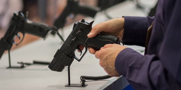 Gun in his hand. Exhibition and sale of weapons