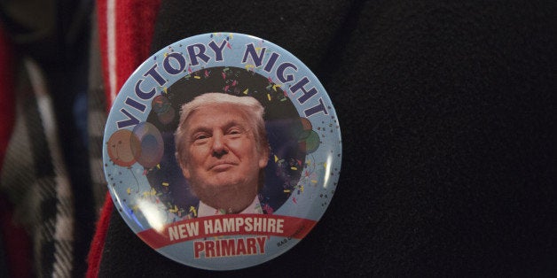 An attendee wears a victory campaign button for Donald Trump, president and chief executive of Trump Organization Inc. and 20