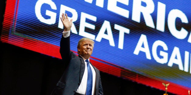 Republican presidential candidate, businessman Donald Trump waves has he arrives for a campaign rally Monday, Feb. 8, 2016, in Manchester, N.H. (AP Photo/David Goldman)