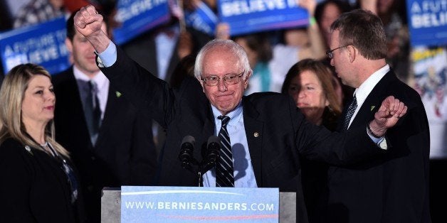 US Democratic presidential candidate Bernie Sanders gestures on stage during a primary night rally in Concord, New Hampshire, on February 9, 2016.Political novice Donald Trump and self-described democratic socialist Bernie Sanders won New Hampshire's presidential primaries Tuesday, US media projected, turning the American political establishment on its head early in the long nominations battle. / AFP / Jewel Samad (Photo credit should read JEWEL SAMAD/AFP/Getty Images)