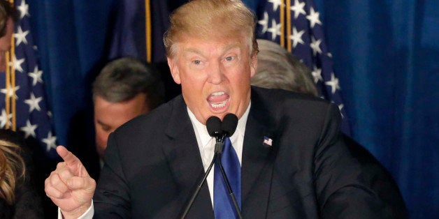 Republican presidential candidate, businessman Donald Trump speaks to supporters during a primary night rally, Tuesday, Feb. 9, 2016, in Manchester, N.H. At his side are his wife Melania Trump, left, and daughter Ivanka Trump, right. (AP Photo/David Goldman)