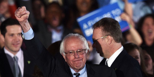 TOPSHOT - US Democratic presidential candidate Bernie Sanders celebrates his victory during the primary night rally in Concord, New Hampshire, on February 9, 2016.Self-described democratic socialist Bernie Sanders and political novice Donald Trump won New Hampshire's presidential primaries Tuesday, US media projected, turning the American political establishment on its head early in the long nominations battle. / AFP / Jewel Samad (Photo credit should read JEWEL SAMAD/AFP/Getty Images)