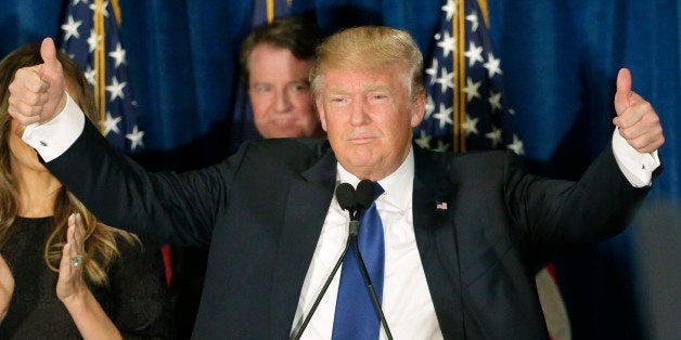 Republican presidential candidate, businessman Donald Trump gives thumbs up to supporters during a primary night rally, Tuesday, Feb. 9, 2016, in Manchester, N.H. (AP Photo/David Goldman)