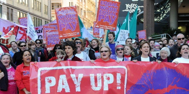 Protesters display banners and palcards as they take part in an 'Equal Pay' rally through Sydney on June 10, 2010. Unions held rallies across Australia to close the gap of 18 per cent between the average pay for men and women. AFP PHOTO / Torsten BLACKWOOD (Photo credit should read TORSTEN BLACKWOOD/AFP/Getty Images)