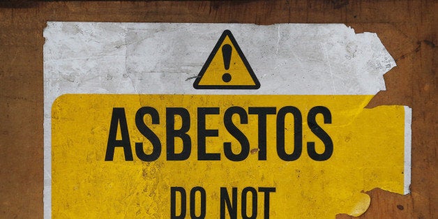 LONDON, ENGLAND - OCTOBER 11: A sign warns of asbestos danger at a former Royal Mail sorting office on October 11, 2013 in London, England. (Photo by Peter Macdiarmid/Getty Images)