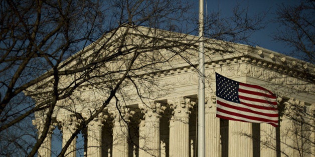 The American flag flies at half-staff in front of the U.S. Supreme Court building in Washington, D.C., U.S., on Tuesday, Feb.
