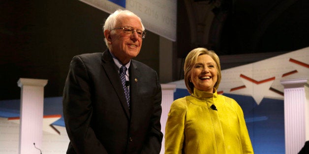 Democratic presidential candidates Sen. Bernie Sanders, I-Vt, left, and Hillary Clinton smile as they take the stage before a