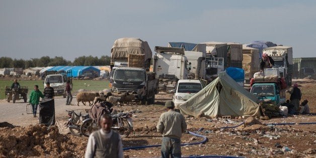 ALEPPO, SYRIA - FEBRUARY 18: Syrians, fled from the attacks of Syrian and Russian air forces, shelter at vehicles and makeshi