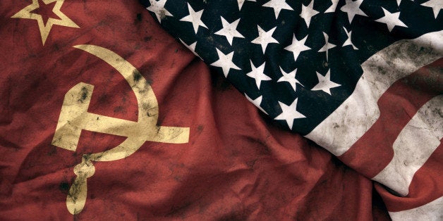 Low key photography of grungy old Soviet Union and United States of America flags. USSR, CCCP, USA.