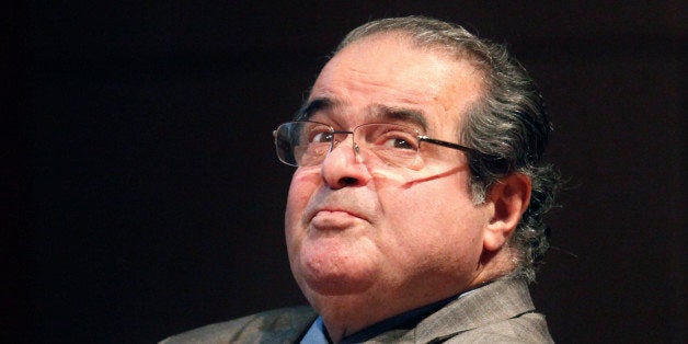 FILE - In this Oct. 18, 2011 file photo, U.S. Supreme Court justice Antonin Scalia looks into the balcony before addressing the Chicago-Kent College Law justice in Chicago. On Saturday, Feb. 13, 2016, the U.S. Marshals Service confirmed that Scalia has died at the age of 79. (AP Photo/Charles Rex Arbogast, File)