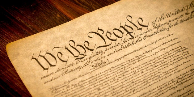 The Constitution of the United States of America on a wooden desk