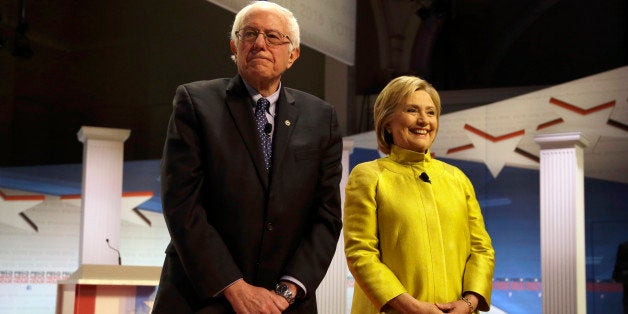 Democratic presidential candidates Sen. Bernie Sanders, I-Vt, left, and Hillary Clinton take the stage before a Democratic pr