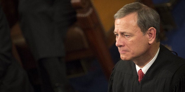 Chief Supreme Court Justice John Roberts listens as U.S. President Barack Obama delivers the State of the Union address to a
