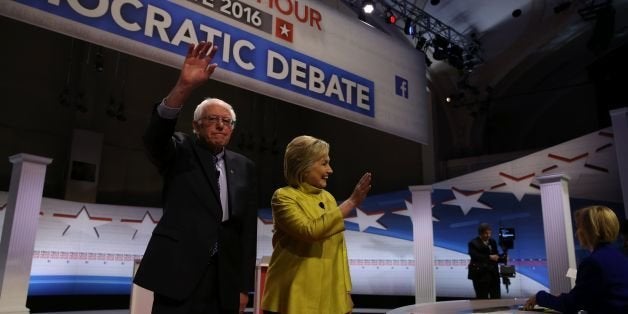 US Democratic presidential candidates Hillary Clinton and Bernie Sanders greet the audience before the PBS NewsHour President