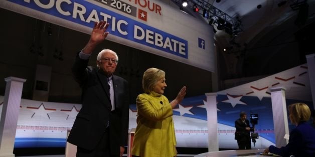 US Democratic presidential candidates Hillary Clinton and Bernie Sanders greet the audience before the PBS NewsHour Presidential Primary Debate in Milwaukee, Wisconsin on February 11, 2016. / AFP / Tasos Katopodis (Photo credit should read TASOS KATOPODIS/AFP/Getty Images)