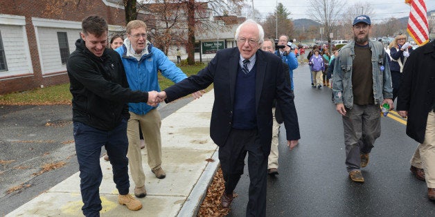 LEBANON, NH - NOVEMBER 11: Presidential candidate Bernie Sanders (I-VT) shakes hands with people as he marches in the Veterans Day Parade November 11, 2015 in Lebanon, New Hampshire. Sanders goes into the Democrats second debate this weekend still running strong in the polls.(Photo by Darren McCollester/Getty Images)