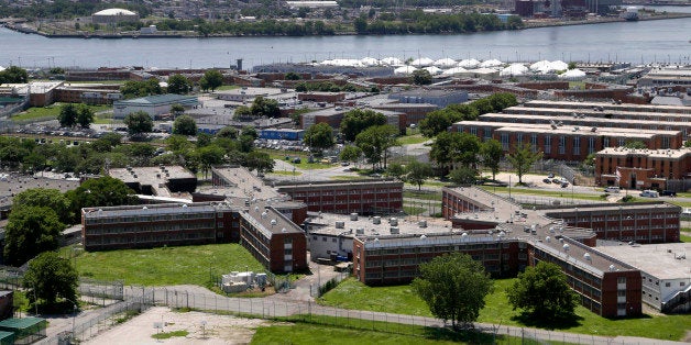 FILE- This June 20, 2014 file photo shows the Rikers Island jail with the New York skyline in the background. New York Mayor Bill de Blasio plans to announce his $130 million, four-year plan to overhaul how the nationâs most populous city deals with mentally ill and drug-addicted suspects, diverting many to treatment instead of jail. (AP Photo/Seth Wenig, File)