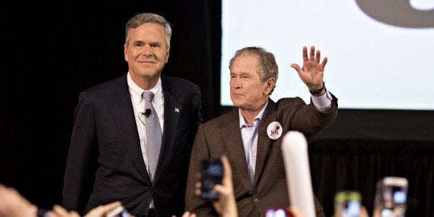 George W. Bush, former U.S. president, right, stands with his brother Jeb Bush, former Governor of Florida and 2016 Republican presidential candidate, as they arrive for a campaign event in North Charleston, South Carolina, U.S., on Monday, Feb. 15, 2016. Former president George W. Bush makes his highly anticipated debut on the 2016 campaign trail, but will not be taking shots at Republican front-runner Donald Trump. 'That's not his job,' Jeb Bush said on Fox News, 'He doesn't have to get into the slop with Donald Trump.' Photographer: Daniel Acker/Bloomberg via Getty Images 