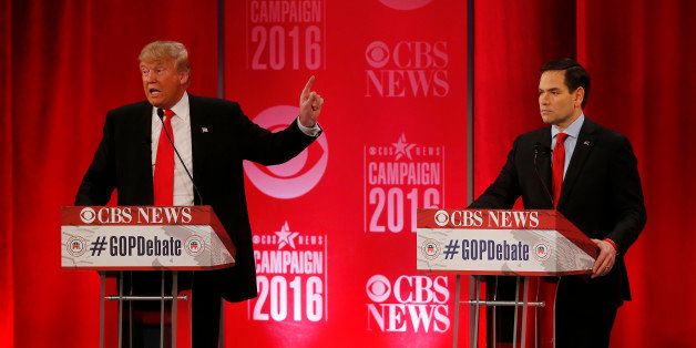 Republican presidential candidate, businessman Donald Trump, left, speaks as Republican presidential candidate, Sen. Marco Rubio, R-Fla., looks on during the CBS News Republican presidential debate at the Peace Center, Saturday, Feb. 13, 2016, in Greenville, S.C. (AP Photo/John Bazemore)