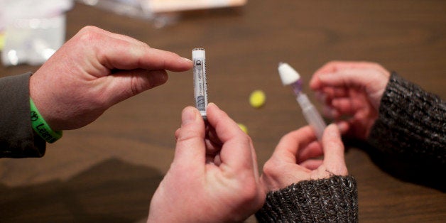 LOWELL, MA - FEBRUARY 27: A member of the Learn to Cope support group trained two fellow members of the group in how to administer Naloxone, a nasal spray that will temporarily reverse the effects of an opiate overdose. Learn to Cope is a support group for the families (mostly parents) of people addicted to opiates. There are local chapters; those one meets at Lowell General Hospital. At the start of each meeting, the group trains newcomers on how to use antidote Naloxone. A pilot program run by the Massachusetts Department of Public Health distributes the antidote Naloxone to anyone who is likely to witness an opiate overdose, including parents and family members of people grappling with addiction. Overdose deaths in the United States have climbed dramatically over the past decade. While Naloxone distribution has been slow to catch on throughout the country, some in addiction medicine hold the state up as a model. A recent study on the Massachusetts program found that communities where the rescue kits were distributed saw their rate of fatal overdoses decline significantly compared with cities and towns with no Naloxone program. (Photo by Dina Rudick/The Boston Globe via Getty Images)