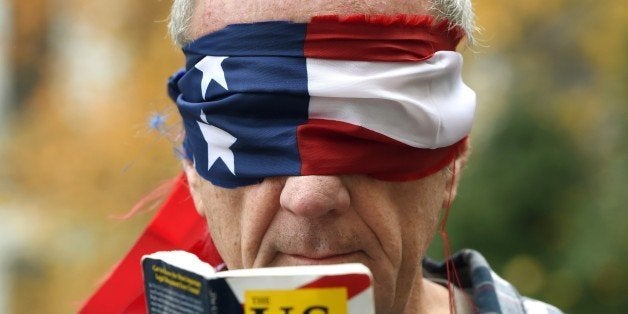 TOPSHOT - A protestor rallys outside the Plaza Hotel on December 11, 2015 in New York, where Republican Presidential hopeful Donald Trump was speaking at a fund-raising luncheon for the Pennsylvania Republican Party. AFP PHOTO / TIMOTHY A. CLARY / AFP / TIMOTHY A. CLARY (Photo credit should read TIMOTHY A. CLARY/AFP/Getty Images)