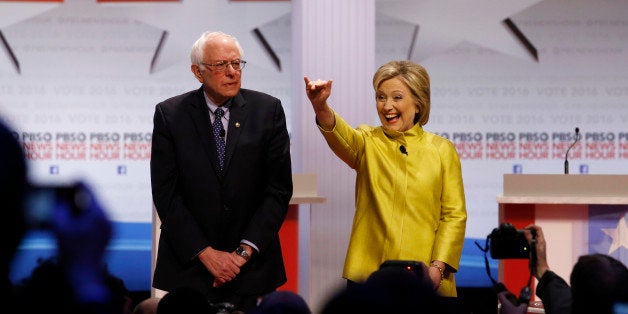 Democratic presidential candidates Sen. Bernie Sanders, I-Vt, left, and Hillary Rodham Clinton take the stage before a Democr
