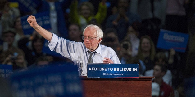 Senator Bernie Sanders, an independent from Vermont and 2016 Democratic presidential candidate, raises his fist after speaking during a campaign rally Milton High School in Milton, Massachusetts, U.S., on Monday, Feb. 29, 2016. Sanders is pinning his hopes for staying in the Democratic presidential race on working-class white voters, the same constituency that helped Hillary Clinton extend her 2008 campaign. Photographer: Scott Eisen/Bloomberg via Getty Images 