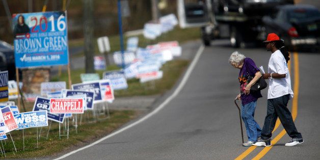BIRMINGHAM, ALABAMA - MARCH 1: Sebastian Connor helps a voter cross the street to reach her polling place at Our Lady-Lourdes Catholic Church in Birmingham, Alabama. 13 states and American Samoa are holding presidential primary elections, with over 1400 delegates at stake. (Photo by Hal Yeager/Getty Images)