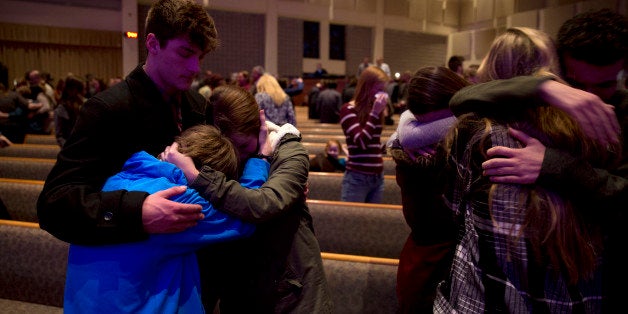 KALAMAZOO, MI - FEBRUARY 21: People gather and pray at Center Point Church following a mass shooting on February 21, 2016 i