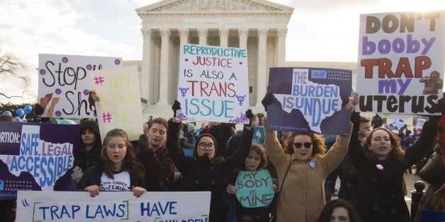 Supporters of legal access to abortion, as well as anti-abortion activists, rally outside the Supreme Court in Washington, DC, March 2, 2016, as the Court hears oral arguments in the case of Whole Woman's Health v. Hellerstedt, which deals with access to abortion. / AFP / SAUL LOEB (Photo credit should read SAUL LOEB/AFP/Getty Images)