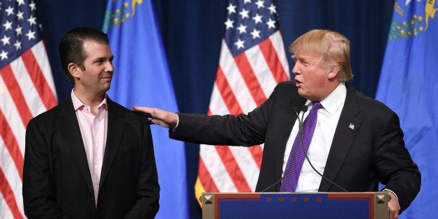 LAS VEGAS, NV - FEBRUARY 23: Donald Trump Jr. (L) looks on as his father, Republican presidential candidate Donald Trump, speaks at a caucus night watch party at the Treasure Island Hotel & Casino on February 23, 2016 in Las Vegas, Nevada. The New York businessman won his third state victory in a row in the 'first in the West' caucuses. (Photo by Ethan Miller/Getty Images)