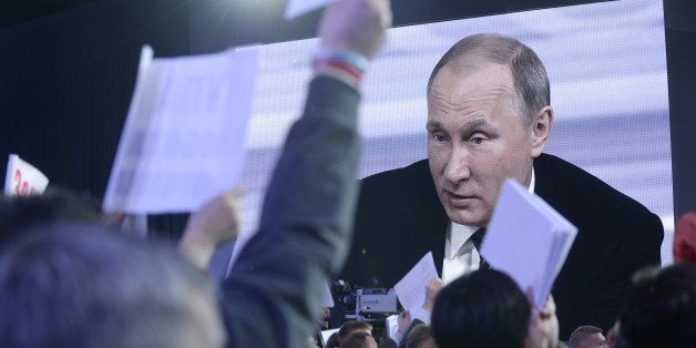 Journalists raise their hands for questions during Russian President Vladimir Putin's annual press conference in Moscow on December 17, 2015. Russian President Vladimir Putin on December 17 described US Republican presidential hopeful Donald Trump as a talented and outstanding man. AFP PHOTO / NATALIA KOLESNIKOVA / AFP / NATALIA KOLESNIKOVA (Photo credit should read NATALIA KOLESNIKOVA/AFP/Getty Images)