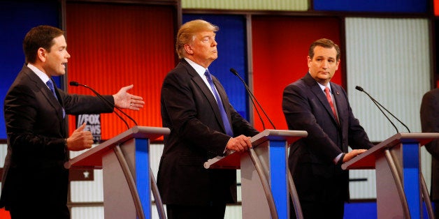 Republican presidential candidate, Sen. Marco Rubio, R-Fla., speaks as businessman Donald Trump and Sen. Ted Cruz, R-Texas, listen during a Republican presidential primary debate at Fox Theatre, Thursday, March 3, 2016, in Detroit. (AP Photo/Paul Sancya)