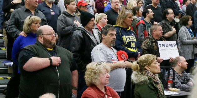 Supporters stand during the national anthem before Republican presidential candidate Donald Trump speaks at a rally at Macomb Community College, Friday, March 4, 2016, in Warren, Mich. (AP Photo/Carlos Osorio)