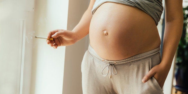 Pregnant woman holding a cigarette