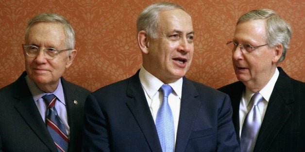 WASHINGTON, DC - NOVEMBER 10: Israeli Prime Minister Benjamin Netanyahu (C) poses for photographs with U.S. Senate Majority Leader Mitch McConnell (R-KY) (R) and Senate Minority Leader Harry Reid (D-NV) in in the Strom Thurmond Room at the U.S. Capitol November 10, 2015 in Washington, DC. Netanyahu met with U.S. President Barack Obama a day earlier when the two leaders talked about fighting terrorism, the conflict in Syria and healing their rift over the Iran nuclear deal. (Photo by Chip Somodevilla/Getty Images)