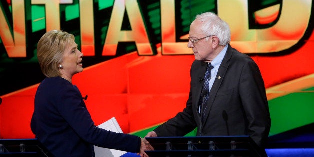 Democratic presidential candidates, Hillary Clinton and Sen. Bernie Sanders, I-Vt., right, shake hands at the end of a Democratic presidential primary debate at the University of Michigan-Flint, Sunday, March 6, 2016, in Flint, Mich. (AP Photo/Carlos Osorio)