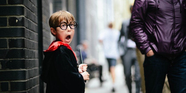 Boy, pretending to be Harry Potter. He is carrying a wand and has his mouth wide open as he pretends to see a Dementor.