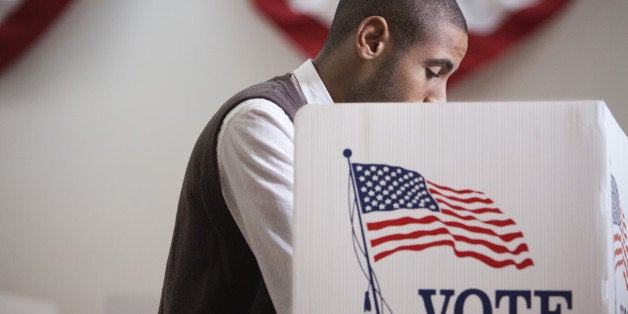 Hispanic voter voting in polling place