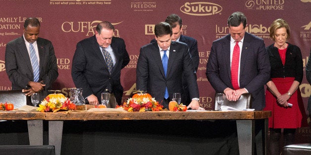 DES MOINES, IA - NOVEMBER 20: Republican presidential candidates (LtoR) Ben Carson, Mike Huckabee, Sen. Marco Rubio (R-FL), Ted Cruz (R-TX), Rick Santorum, and Carly Fiorina pray following the Presidential Family Forum on November 20, 2015 in Des Moines, Iowa. Attendance at the event was lower than organizers had hoped as an early-winter snowstorm moved through the area dumping several inches of snow on the city. (Photo by Scott Olson/Getty Images)