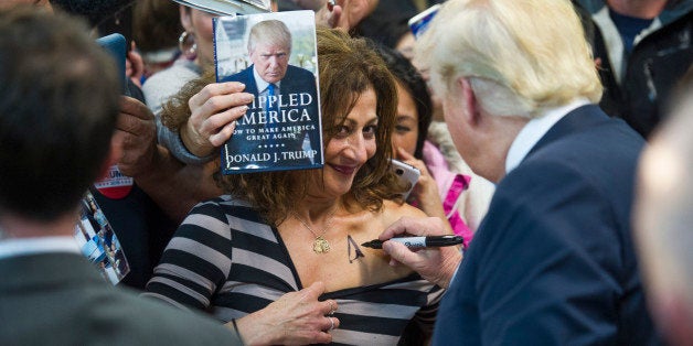 Republican presidential candidate Donald Trump autographs a supporter's chest following his speech at a campaign rally at Prince William County Fair Grounds Wednesday, Dec. 2, 2015, in Manassas, Va. (AP Photo/Cliff Owen)