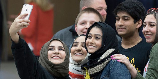 WICHITA, KS - MARCH 5: A group of Muslim students take selfies before Republican presidential candidate Donald Trump made a speech at a campaign rally on March 5, 2016 in Wichita, Kansas. During the speech, after they voiced some protests, they were removed from the convention center. (Photo by J Pat Carter/Getty Images)